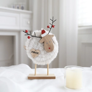 Detail of wool felt Christmas reindeer ornament with wooden heart and Xmas engraving