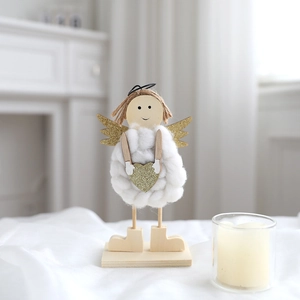 Handcrafted felt angel ornament with wooden head and gold wings on a steady wood base
