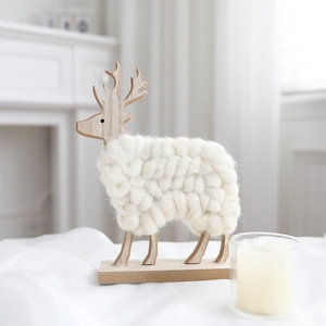 Macro detail of reindeer decor featuring natural wood grain and woven white wool texture
