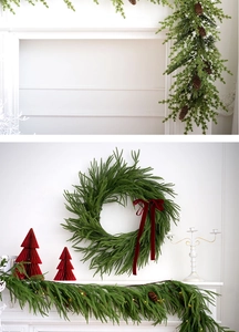 Detail of a PE Christmas wreath and garland set with velvet bows and warm LED lights