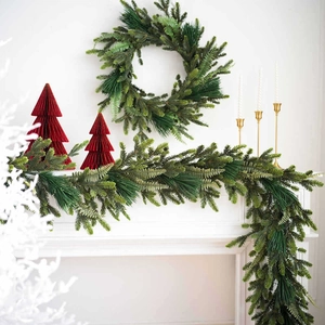 Green PE Christmas wreath and garland set displayed on a white minimalist fireplace mantel