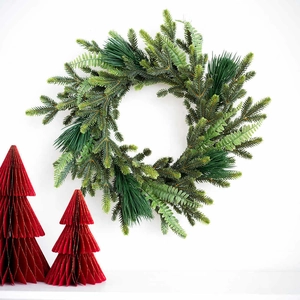 Lush evergreen Christmas wreath with dense pine needles and ferns on white backdrop