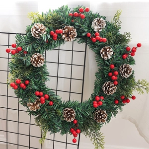 Couronne de Noël artificielle avec aiguilles de pin, baies rouges et pommes de pin