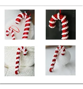 Detail of red and white Christmas candy cane ornaments with glitter and white pom-poms