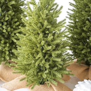 Three mini flocked PE Christmas trees with burlap bases for festive tabletop decor