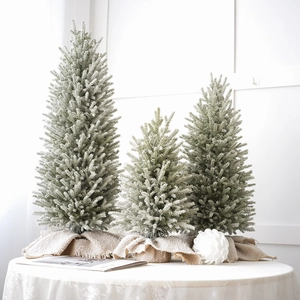 Three mini flocked PE Christmas trees with burlap bases for festive tabletop decor