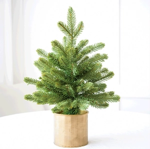 Close-up of mini flocked Christmas tree with realistic green needles and gold metal base