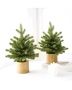 Mini artificial Christmas trees with green needles and gold metal pots for holiday decor
