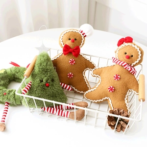 Detail of plush gingerbread man dolls and furry green Christmas tree ornaments in basket