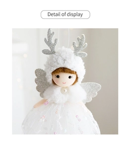 Close-up of angel ornament with silver glitter wings and sequin mesh skirt detail