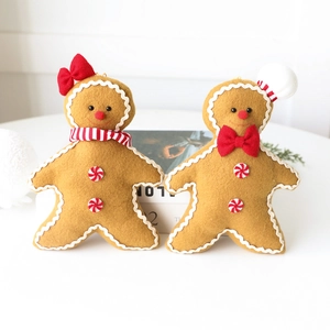 Pair of plush gingerbread man Christmas ornaments with chef hat and striped scarf