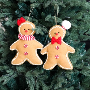 Plush gingerbread man Christmas tree ornaments with festive scarves and chef hats
