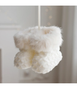 Close-up of white plush Christmas boot ornament with faux fur and woven texture
