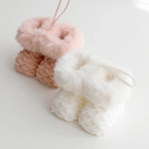 Plush knitted Christmas stocking ornaments in pink and white with faux fur trim
