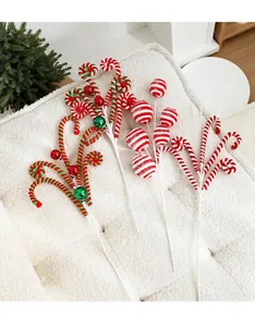 Detail of plush Christmas tree picks with candy cane balls and colorful bells ornaments