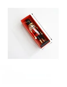 Detail view of a 17cm wooden nutcracker soldier doll in a red and gold gift box