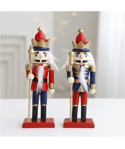 Detail showing two traditional wooden nutcracker soldiers with red and blue uniforms on a base