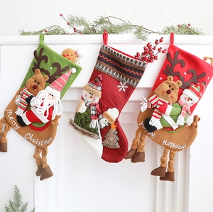 Detail of 3D Christmas stockings with plush Santa, reindeer, and snowman designs