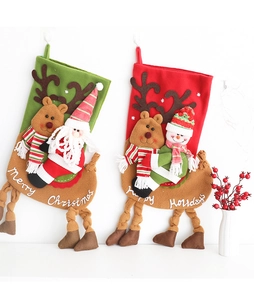 Detailed view of plush Christmas stockings with Santa and Snowman embroidery in red and green