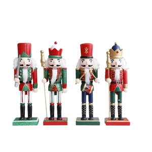 Set of four traditional wooden nutcracker soldier figurines with festive glitter details