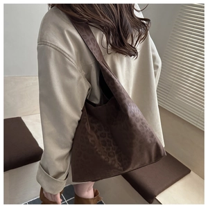 Macro detail of large leopard print suede tote bag showing soft texture and draping