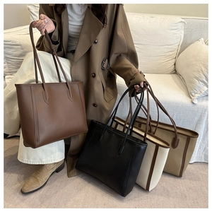 Detail view of stylish tote bags in four colors shown with model on a sofa for winter fashion