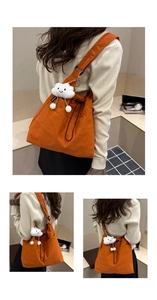 Detail of orange nylon tote bag with fashion cloud pendant and lightweight texture