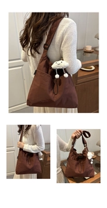 Detail of coffee brown large canvas tote bag with drawstring and plush cloud pendant