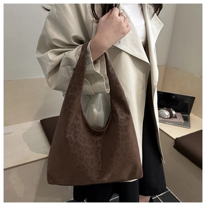 Detail of dark brown leopard print hobo tote bag in soft suede finish for women