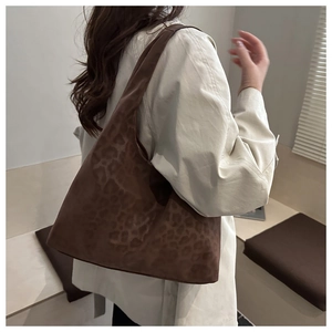 Detail of soft leopard print tote bag with wide shoulder strap in matte dark brown
