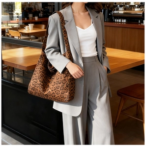 Close-up of leopard print tote bag texture in retro suede fabric on model's shoulder
