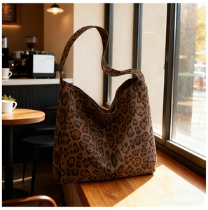 Detail shot of leopard print hobo tote bag featuring premium suede-like texture and soft finish