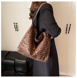 Detailed close-up of leopard print oversized tote bag with suede texture on model