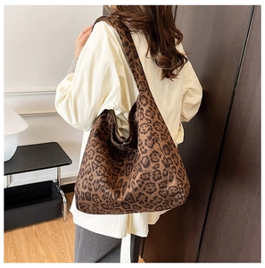 Close-up of stylish leopard print hobo bag worn by model showing large capacity design