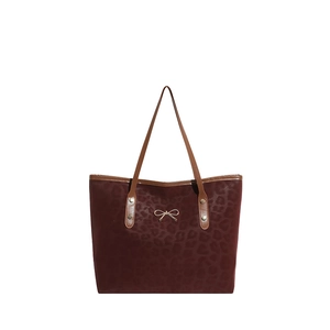 Burgundy leopard print tote bag with gold bow accent and slim brown handles for women