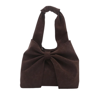 Deep brown suede tote bag with large bow decoration and minimalist shoulder strap design