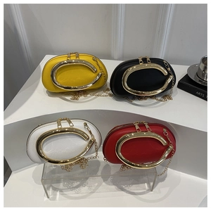 Detail of colorful semi-oval acrylic evening bags with gold C-handle and chain strap