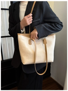 Detail view of cream leather tote with brown straps and New York fashion print