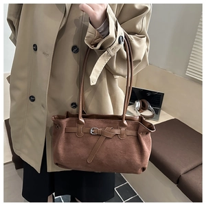Detail of vintage dark brown frosted tote bag with adjustable buckle strap and laptop