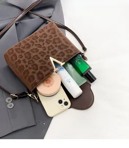 Leopard print crossbody bag interior showing storage for phone and cosmetics