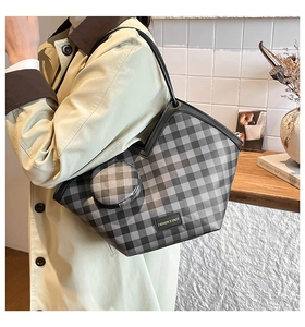 Checkered tote bag with matching round pouch shown on model in a cozy setting