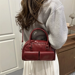 Deep red vintage bowling bag for women with dual pockets and adjustable strap