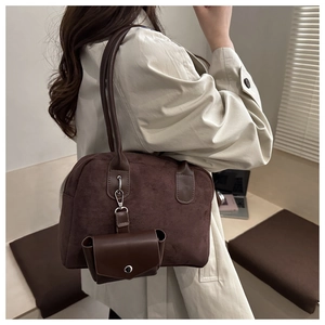 Deep brown faux suede Boston bag with smooth leather handles and a matching mini pouch