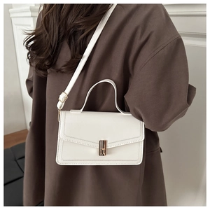 Close-up of a white leather crossbody bag with a gold metal buckle and stitching details