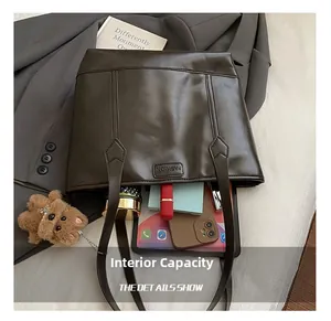Macro shot showing internal capacity of coffee brown tote bag with tablet and phone