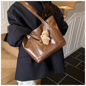 Deep brown oversized tote bag in matte PU leather with a cute plush teddy bear charm