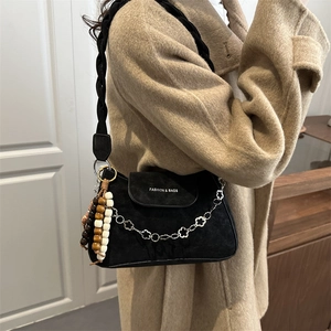 Black suede vintage underarm bag with woven strap and decorative floral chain