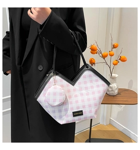 Detail of V-neck tote bag with pink checkered pattern and small round pendant wallet