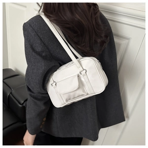 White oil wax leather shoulder bag shown on model with vintage style side pocket