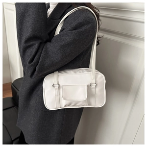 Close-up of minimalist white square bag with front flap pocket and sleek silver hardware